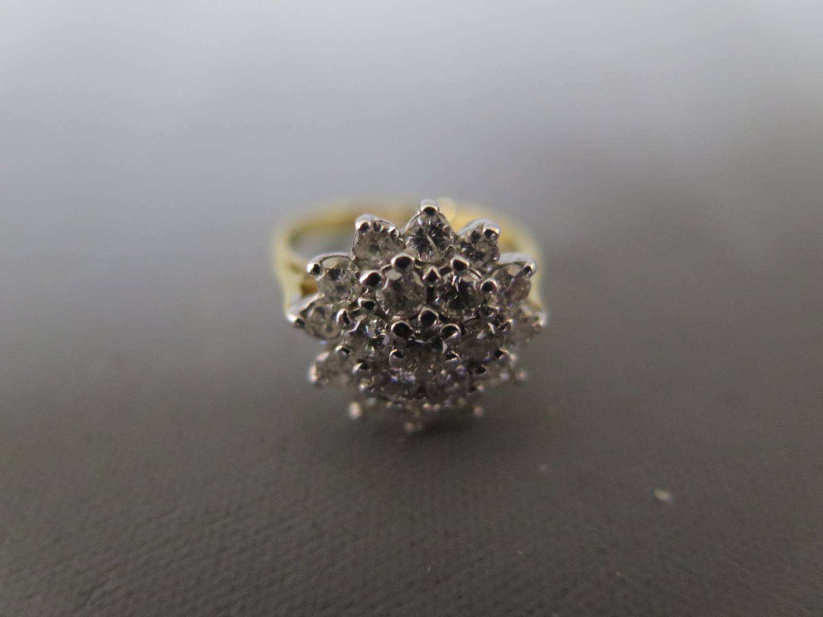 An 18ct yellow gold and diamond cluster ring size H - approx weight 4 grams - clean and bright