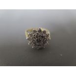 An 18ct yellow gold and diamond cluster ring size H - approx weight 4 grams - clean and bright