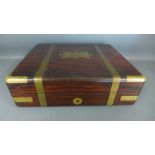 A rosewood and brass bound box with a hinged lid opening to reveal sectional compartments - 29.