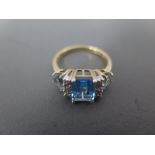 A 10ct yellow gold light blue stone and diamond chip ring size N - approx weight 2.