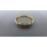 A 18ct yellow gold three stone diamond ring, the small diamond in heart shaped setting - approx 3.