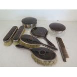A tortoiseshell and silver dressing set consisting of hairbrushes, clothes brushes, hand mirror,