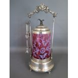 A cranberry glass and silver plated pickle castor
