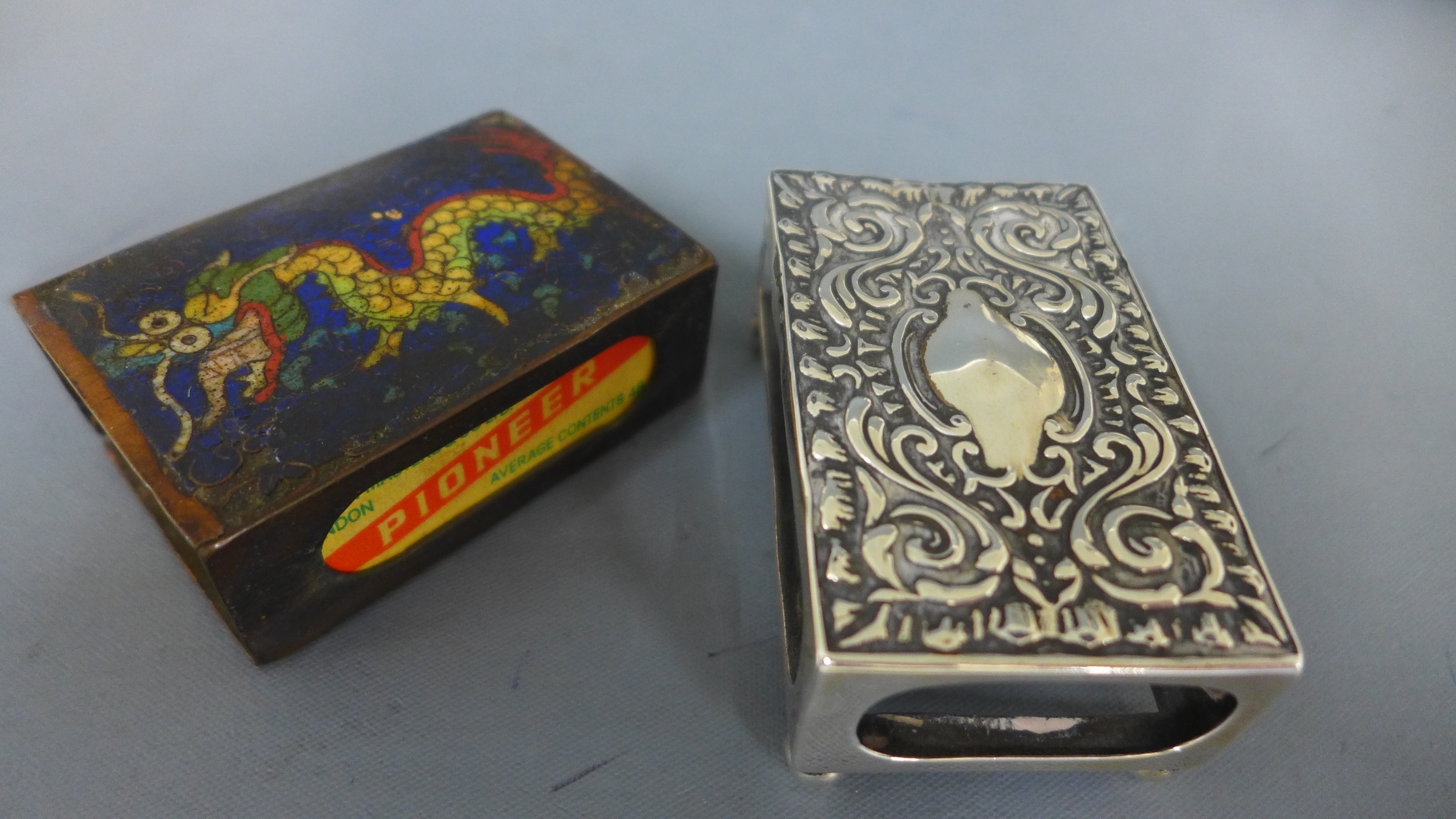 A Cloisonne dragon match box holder and a silver match box holder - some enamel missing to dragon