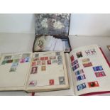 A tin containing loose World stamps and two albums containing British and World stamps