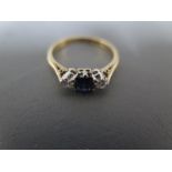 A sapphire and diamond ring in 9ct yellow gold setting - approx weight 2.