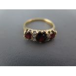 A garnet and diamond yellow gold ring,