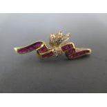 A diamond and ruby brooch set in 15ct yellow gold - approx weight 4.