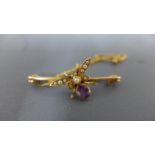 A brooch in the form of a bee with seed pearls to wings and amethyst to abdomen,
