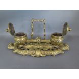 A brass desk stand with twin inkwells with embossed finish - clean,