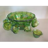 A green Carnival glass punch bowl and twelve glasses - Height 18cm x Diameter 31cm - in good order,