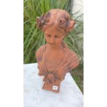 An Art Nouveau style cast stone bust of a young girl with flowers in her hair - Height 46cm x Width