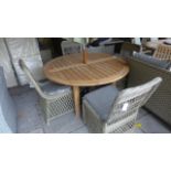 A Bramblecrest teak circular garden table with four chairs, cushions,