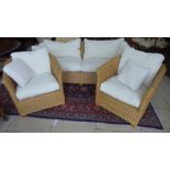 A wicker conservatory suite - sofa and two chairs with cushions