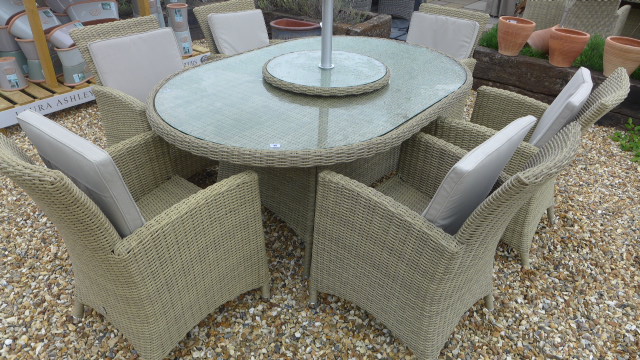 A Bramblecrest Cotswold 170cm x 115cm oval table with six chairs, cushions,