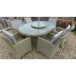 A Bramblecrest Cotswold 170cm x 115cm oval table with six chairs, cushions,