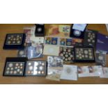 A collection of proof and definitive coin sets including an England winners 2oz silver coin and