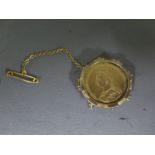 A Victorian full Sovereign dated 1887 in a yellow metal brooch mount