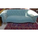 A Victorian button back sofa re upholstered in a blue fabric