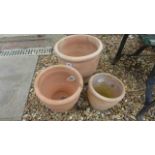 A set of three graduating terracotta pots