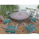 An aluminium garden table and eight chairs with cushions by Oxley,