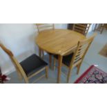 A modern drop leaf table and four chairs