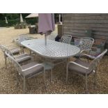 A secondhand Hartman eight seater aluminium oval dining table with eight chairs, cushions,