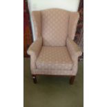 A modern reproduction wing armchair