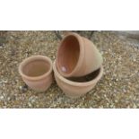 A set of three graduating terracotta pots