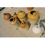 Seven assorted stoneware wine and spice bottles,