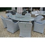 A Bramblecrest Monterey 220cm x 145cm elliptical table with eight armchairs,