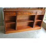 A reproduction yew wood triple open bookcase,