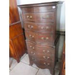 A mahogany old reproduction small serpentine chest on chest with a brushing slide - 140cm x 66cm