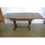 A 1930's carved oak drawer leaf table - Height 75cm x 75cm x 183cm