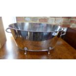 A large oval silver plated champagne bath on four feet - Height 22cm x Width 54cm