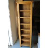 A Besp-oak Vancouver solid oak slim CD/DVD bookcase with fixed shelves - Height 185cm x 56cm x 24cm