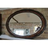 A circa 1900's cushion framed oval mirror - 66cm x 90cm
