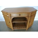 A canted corner pine sideboard with open centre flanked by two cupboards, single centre drawer,