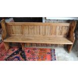 A late Victorian pine pew - Height 92cm x Width 200cm