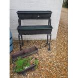 A cast iron two tier planter,