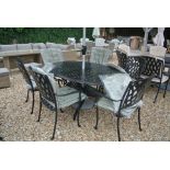 A Bramblecrest black Rome 167cm x 112cm elliptical table with six stacking armchairs, cushions,