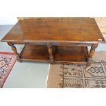 An antique style oak coffee table with under tier - Height 47cm x 121cm x 59cm