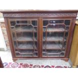 A mahogany glazed two door bookcase - Width 138cm x Height 114cm