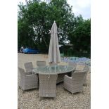 A Bramblecrest Patagonia 220cm x 145cm elliptical table with eight armchairs and cushions,