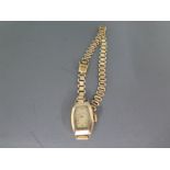 A 9ct gold cased Ladies wristwatch on a gold plated bracelet strap,