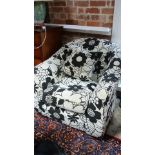 A black and white floral upholstered chair