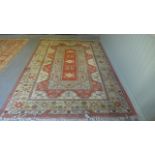 A hand knotted woolen rug with geometric design - 306cm x 208cm