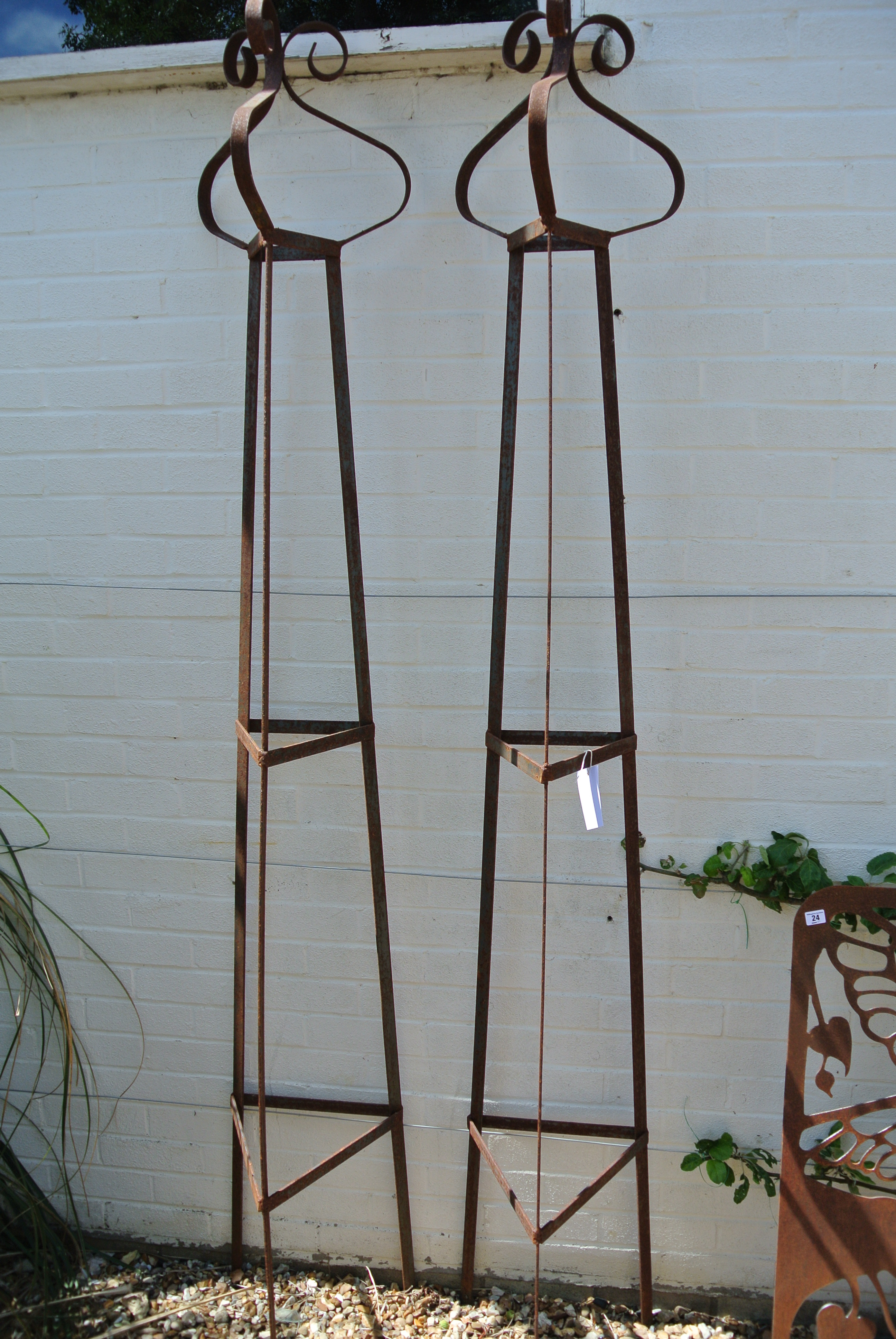 A pair of wrought iron triangular garden obelisks with scroll finials - Height 235cm x 39cm square