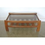 A teak and smoked glass topped coffee table - 102cm x 53cm x 40cm high