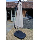 A Bramblecrest Gloucester cantilever parasol with water filled base